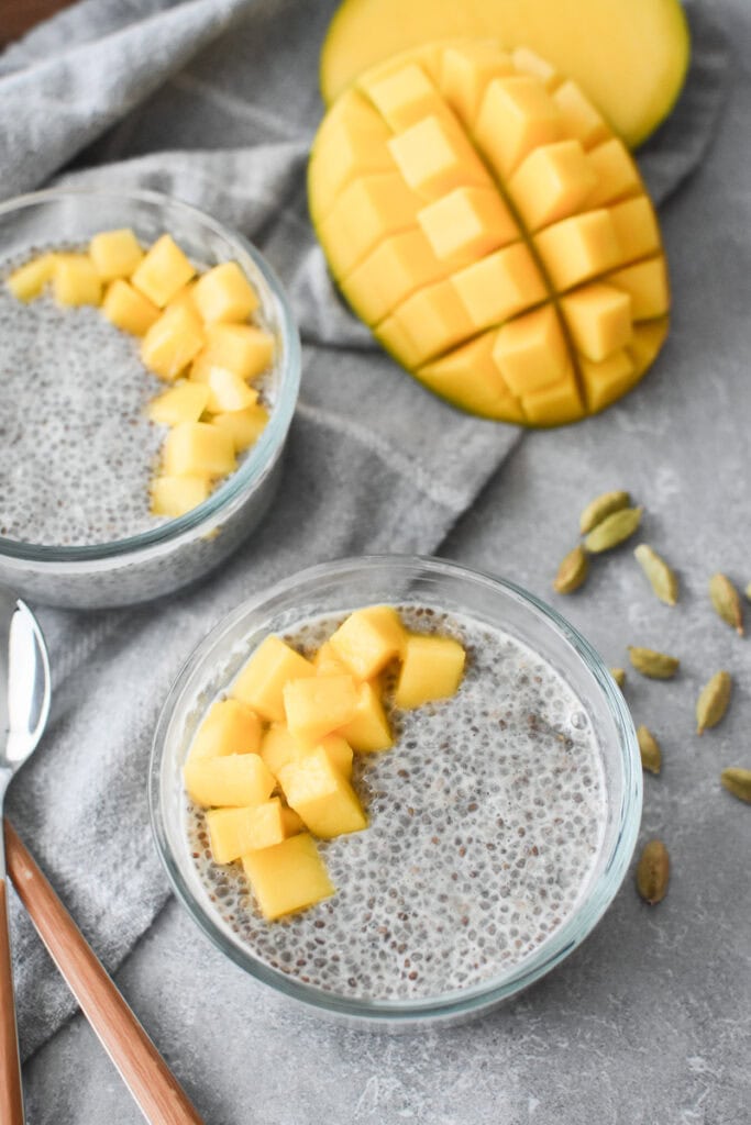 Two glass bowls filled with chia seed pudding and mango.