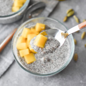 Two glass bowls filled with chia seed pudding and mango.