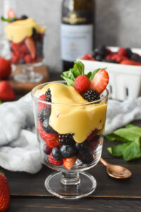 A cup of berries with zabaglione custard on top