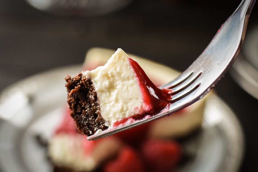 This healthy, 21 Day Fix Brownie-Bottom Cheesecake with Raspberry Sauce is the perfect make-ahead dessert for your holiday dinner or special occasion!
