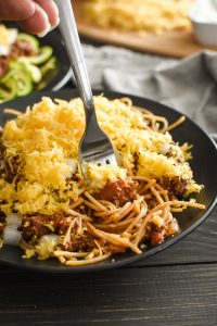 This Healthy Cincinnati Chili is a quick, easy, full-of-flavor, kid-friendly dinner! It's gluten free (served with zoodles or pasta). 21 Day Fix | Weight Watchers Freestyle Points #21dayfix #portionfix #quickdinner #gameday #weightwatchers #healthy #healthydinner #glutenfree #cincinnati #weightloss #mealprep #kidfriendly #familyfriendly