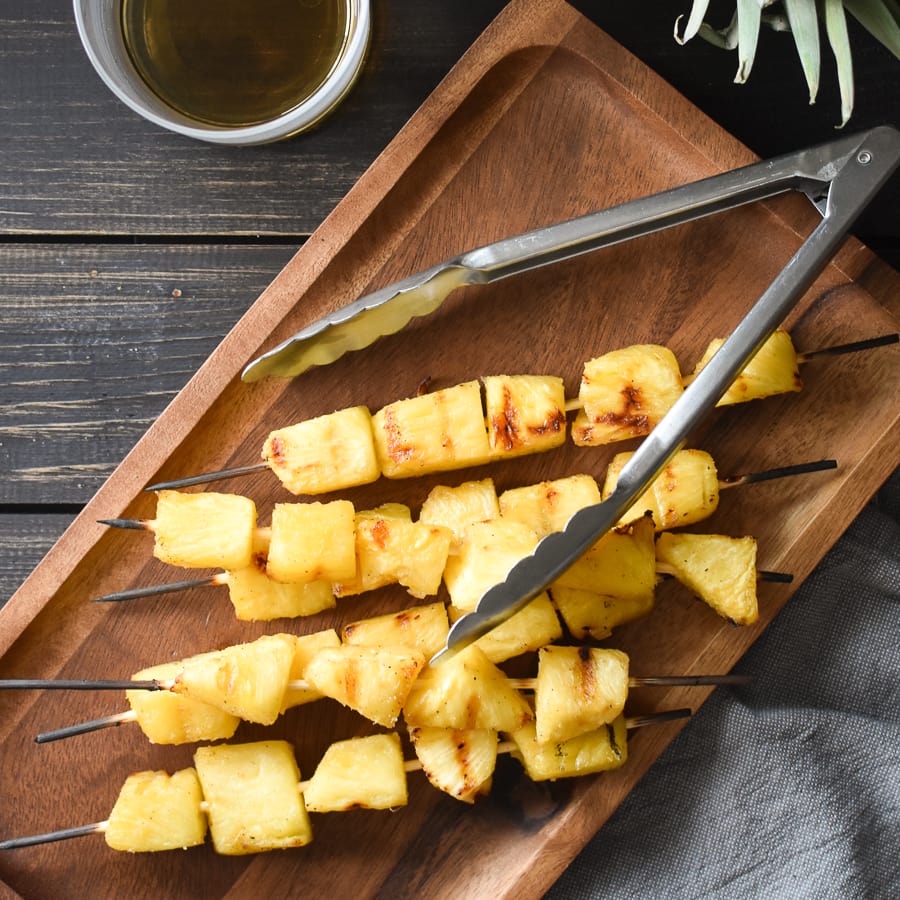 This simple rum-marinated grilled pineapple is full of flavor and a makes for a delicious, healthy side dish! It's also vegan, gluten free and dairy free! #21dayfix #ultimateportionfix #portionfix #weightwatchers #grill #grillrecipe #grilling #bbq #healthy #sidedish #healthyside #vegan #vegetarian #glutenfree #dairyfree #healthygrilling