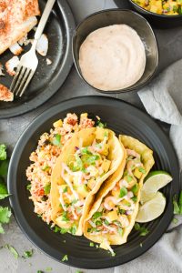 two fish tacos with mango salsa and chipotle mayo