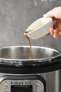 Maple syrup being poured into an Instant Pot