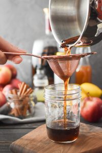 straining syrup into a jar