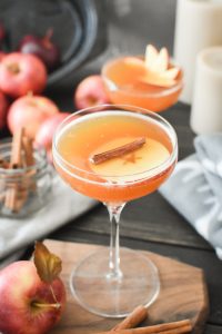a Cocktail garnished with an apple slice