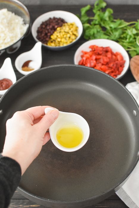 Adding olive oil to a pan