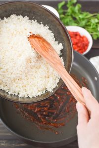 Adding cauliflower rice to a pan