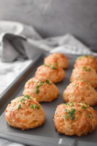 a baking sheet full of whole wheat cheddar bay biscuits