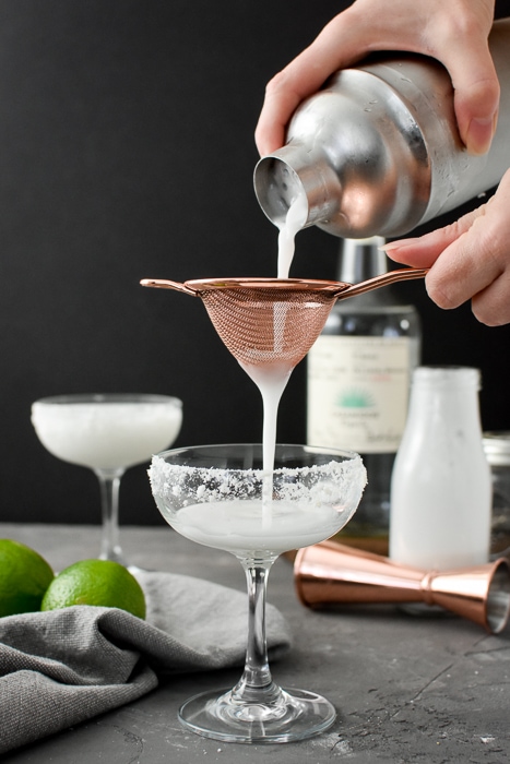 Double-straining a Skinny Coconut-Lime Margarita