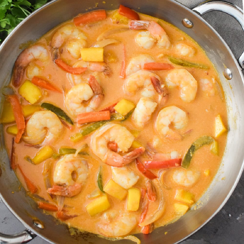 Thai Shrimp Mango Red Curry in a large steel saute pan.