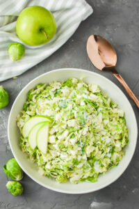 a bowl of green apple and brussels sprout slaw