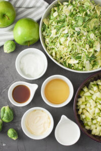 an overhead photo of ingredients for green apple and brussels sprout slaw