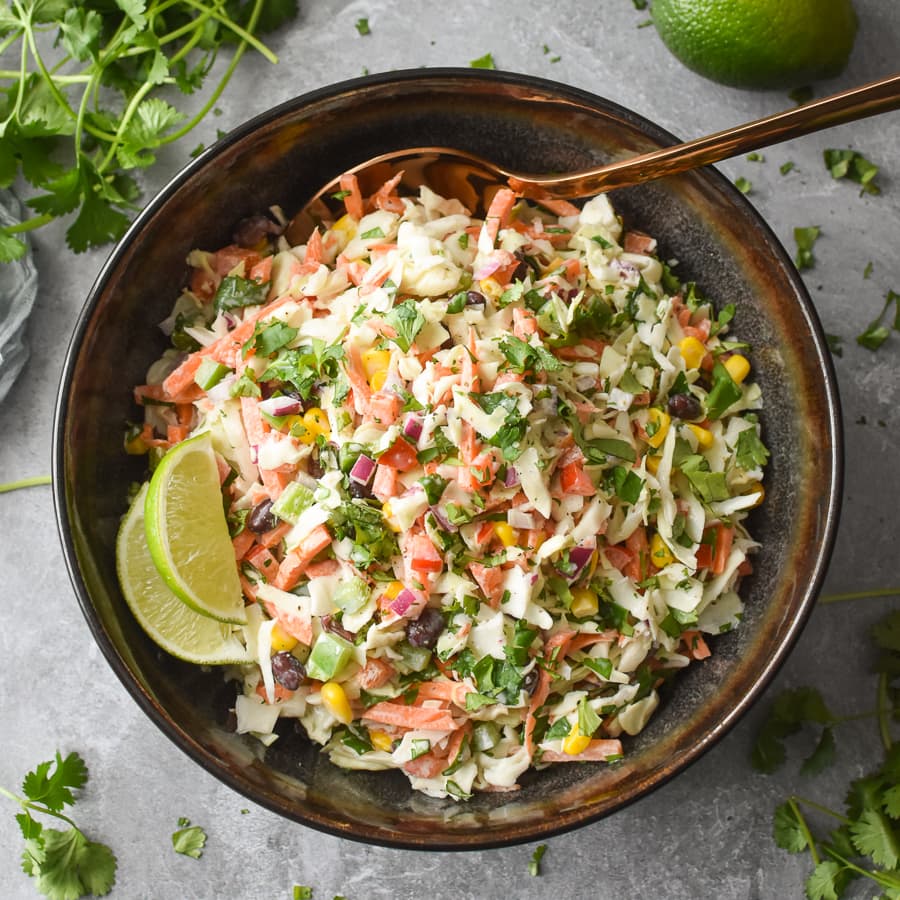 This easy Creamy Mexican Coleslaw recipe is a healthy and delicious side dish to go with your favorite Mexican eats! Plus it's gluten-free, 21 Day Fix approved and Weight Watchers friendly! #21dayfix #tacotuesday #beachbody #weightwatchers #sidedish #healthyside #mealprep #kidfriendly #glutenfree #vegetarian #healthy