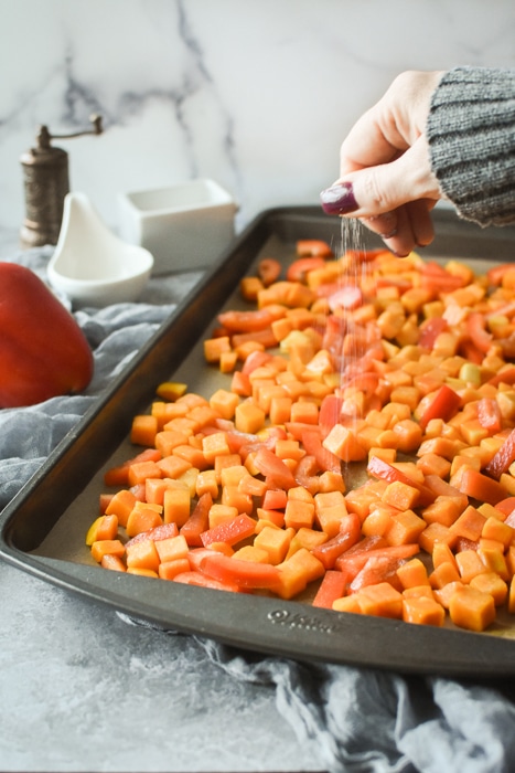seasoning a sheet pan of vegetables with salt