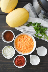 Overhead photo of all of the ingredients for chili cheese burrito spaghetti squash bowls