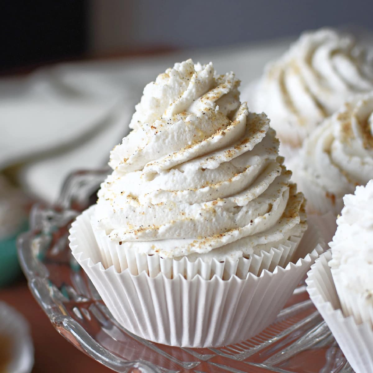 A healthy banana cupcake topped with coconut whipped cream.