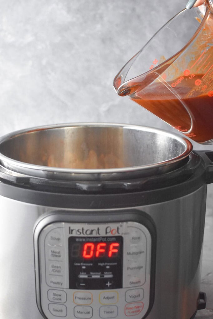 Adding Apple Cider BBQ sauce to an Instant Pot.