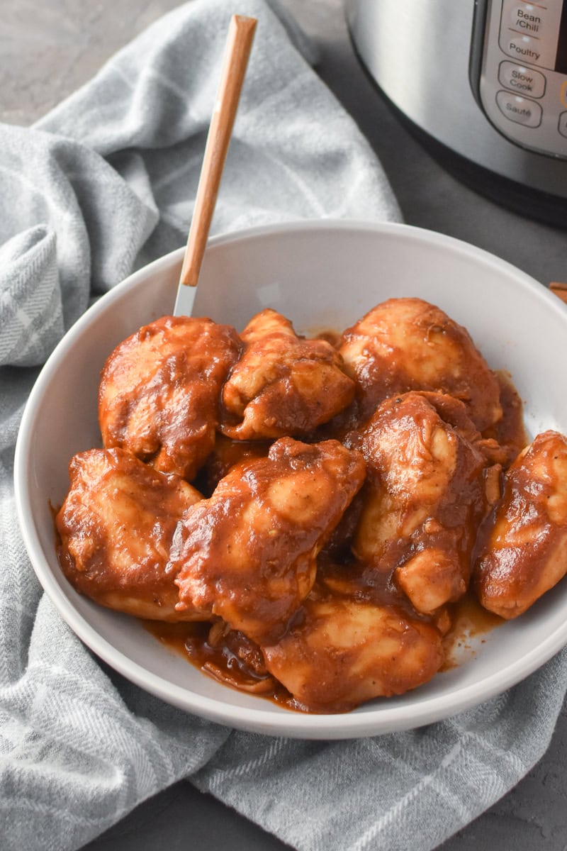 A serving bowl of Instant Pot Apple BBQ Chicken Thighs