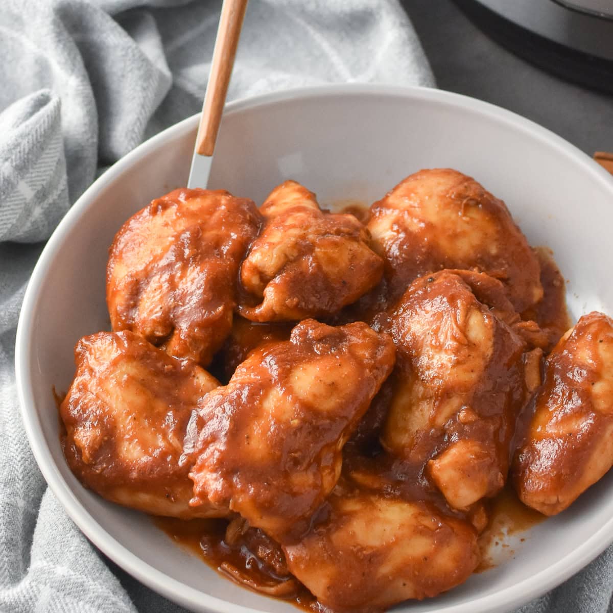 A serving bowl of Instant Pot Apple BBQ Chicken Thighs