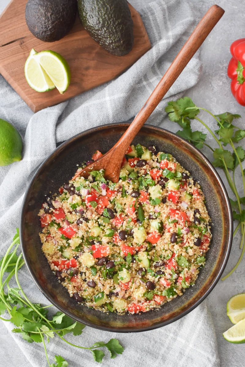 a brown bowl filled with cilantro-lime quinoa salad