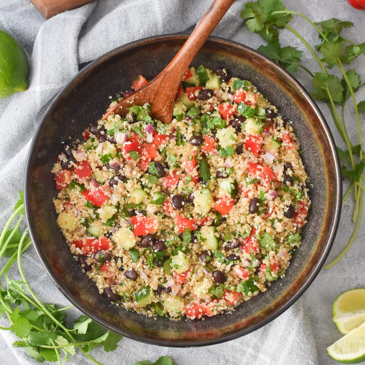 a brown bowl filled with cilantro-lime quinoa salad