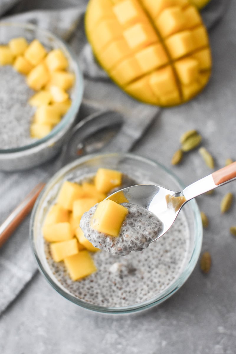 Two glass bowls filled with chia seed pudding and mango.